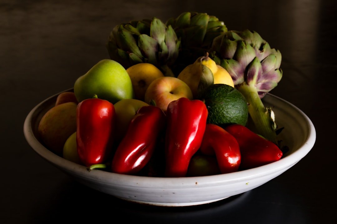 Colorful array of fresh California produce including avocados, citrus, leafy greens, and berries at a farmers market